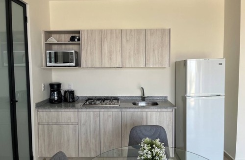 Zapopan Apartment | Apartment in Zapopan, Jalisco, with a view of the mountains and a pool