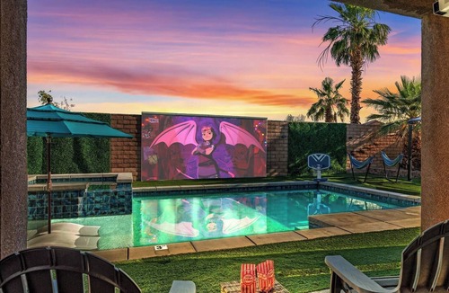 Terra Lago House | This spacious Indio home is designed for families, golf trips, festival weekends, and guests who want built-in entertainment. Enjoy a private saltwater pool, free spa, golf simulator, poolside cinema, game room, glamping yurt, hammocks, and karaoke.