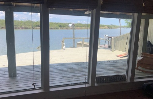 Rio Hondo House | Waterfront 4 bedroom cabin with a great location for fishing in its backyard.