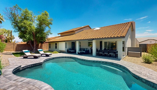 A stately luxury house with pool nestled in a serene neighborhood