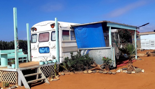 Cozy converted bus located 10 min walk from the beach .