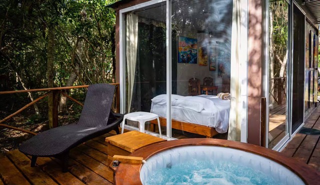 Jungle Cabana with 2 beds, AC, and private Hot Tub.