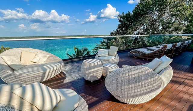 Luxury waterfront villa with dock, pool, hot tub, outdoor areas, & billiards