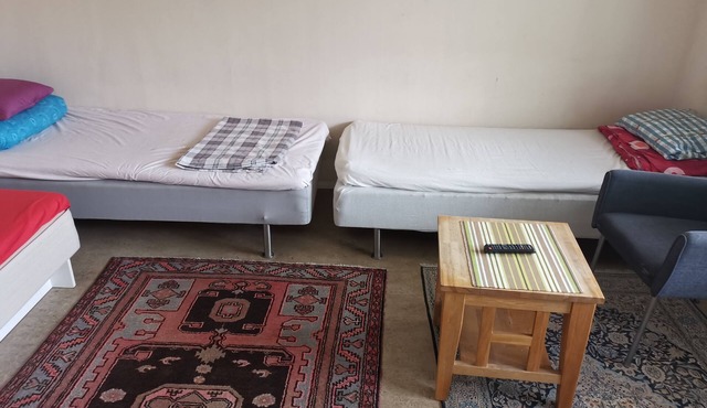 One large room with 3 single beds. Max for three people 12 min from city center