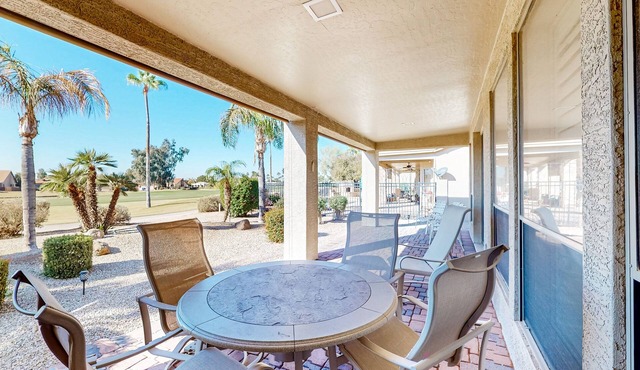 Palm-lined home with pool access, grill, office & golf course views