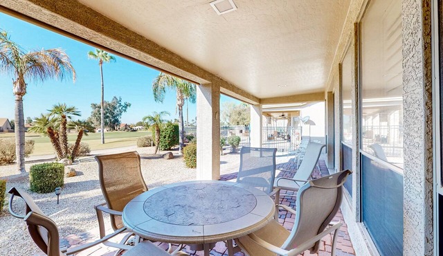 Palm-lined home with pool access, grill, office & golf course views