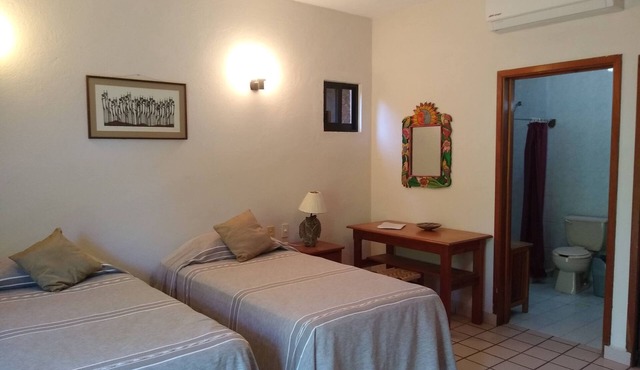 Spacious room in family guesthouse walking distance to La Ropa beach