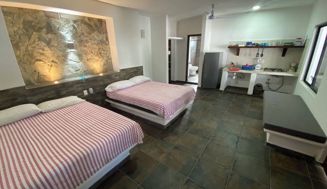 Suite with 2 dbl beds, kitchen, fans and AC. Just 2 blocks from beach.